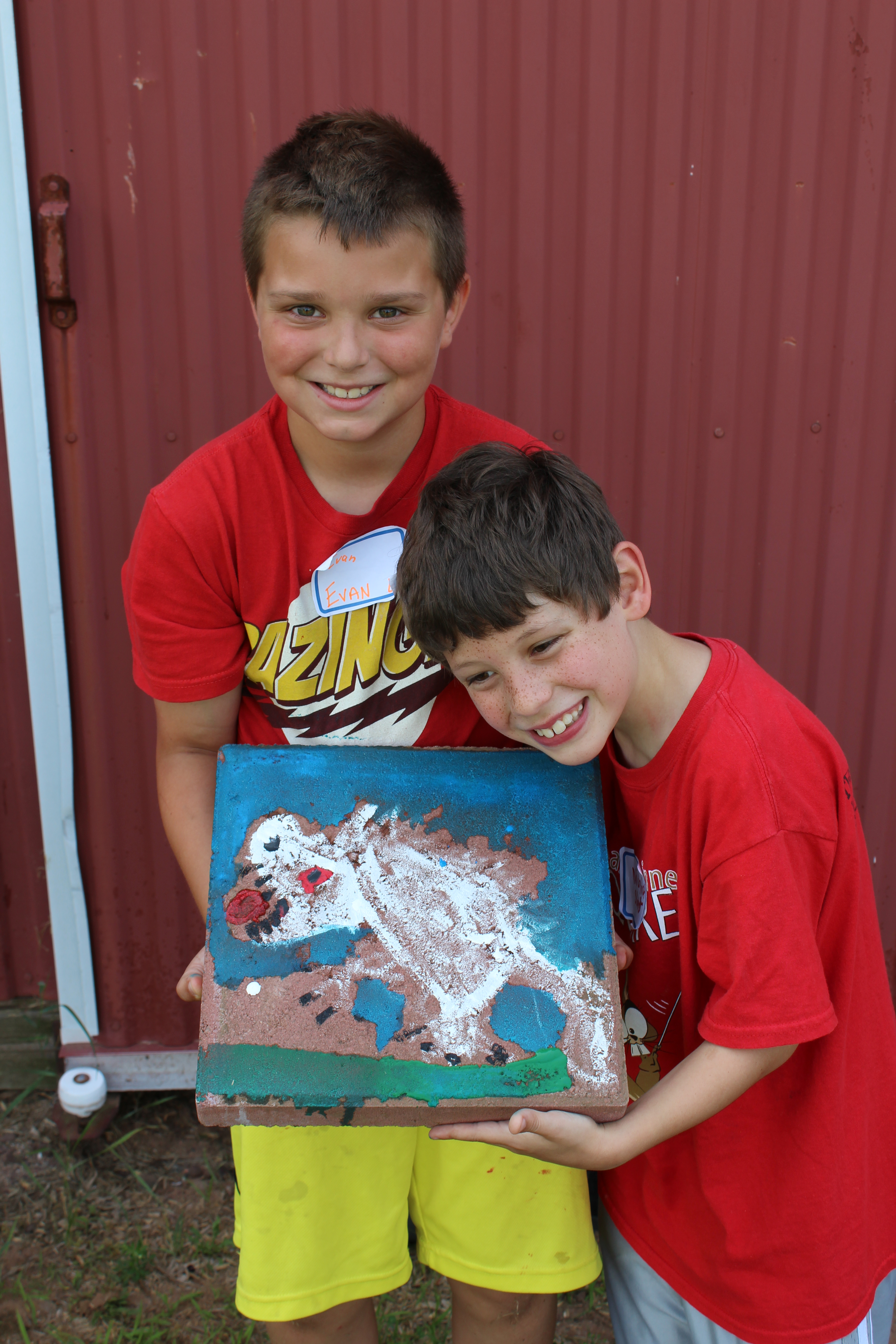 Two little boys posing with their painting