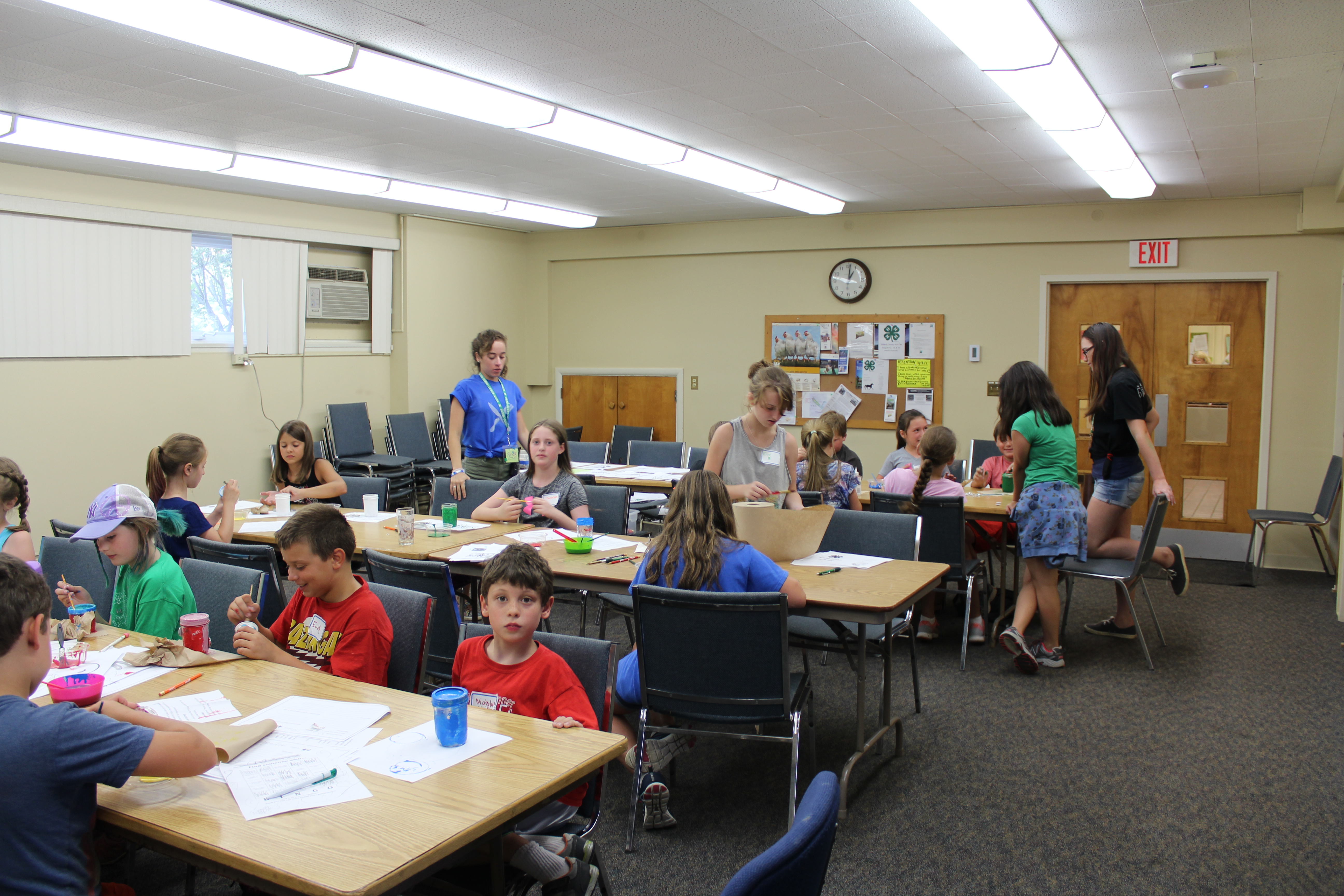 Kids sitting at tables, crafts