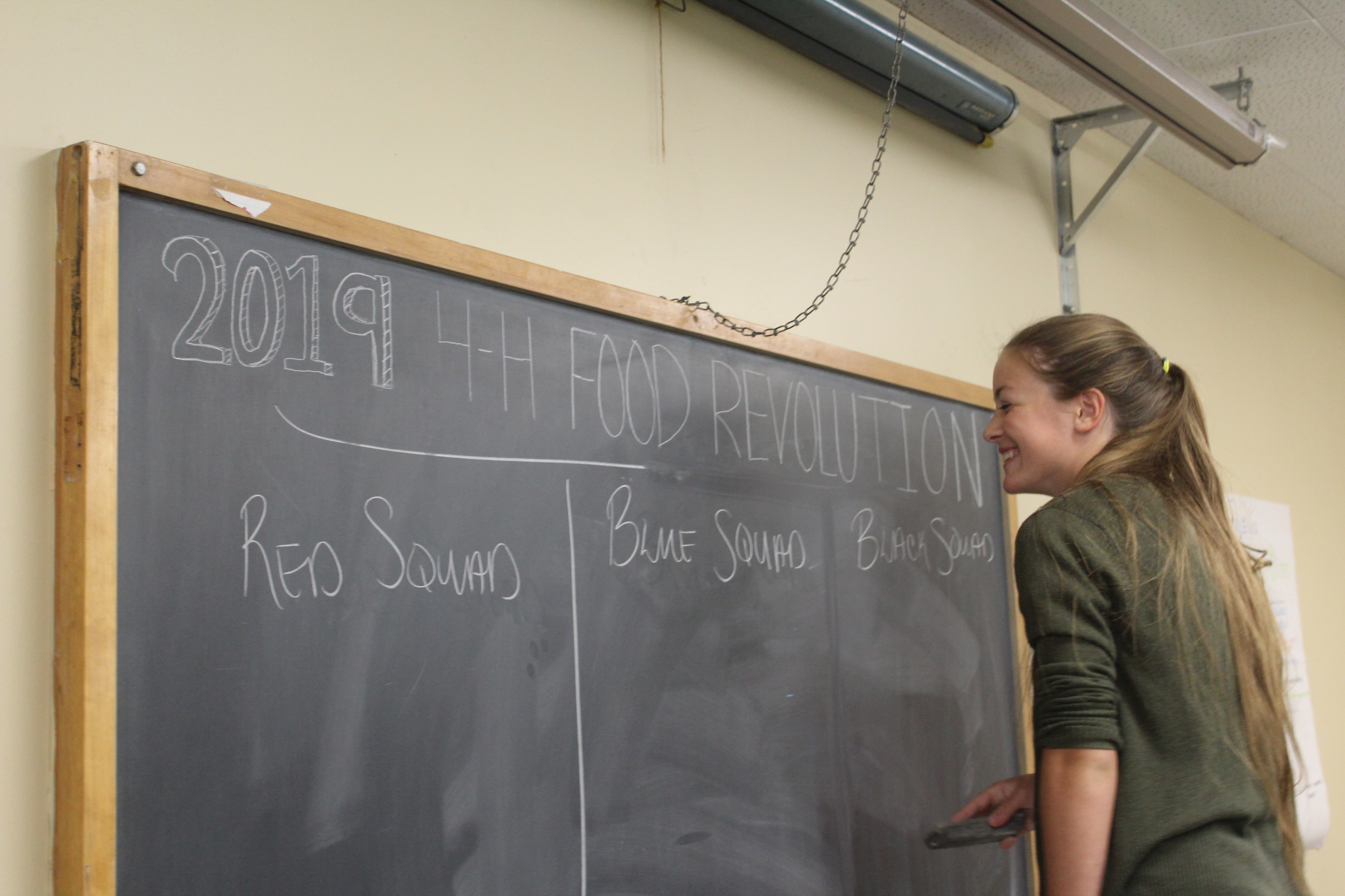 Girl writing on chalk board